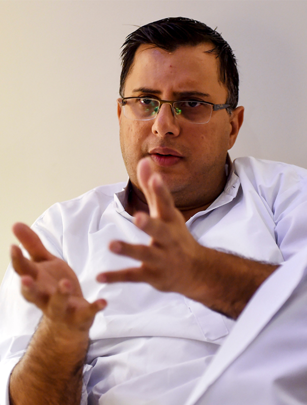 Pakistani police officer and crime stories writer Omar Shahid Hamid gestures as he speaks during an interview with AFP in Karachi. - Personal tragedy haunts the hard-boiled novels that are turning top cop Omar Shahid Hamid into one of Pakistan's most popular English-language authors