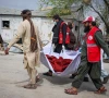 red crescent volunteers carry the body of a victim who died in what the taliban said was a pakistani air strike on a drug rehabilitation hospital in kabul afghanistan photo reuters