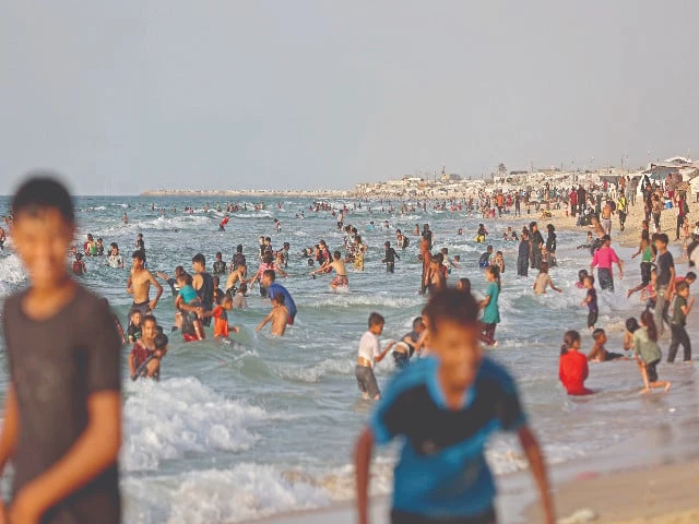 displaced palestinians swim in the mediterranean sea on the shores of khan yunis in the southern gaza strip photo afp