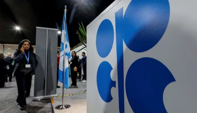 a woman passes by a logo of organization of the petroleum exporting countries opec during the united nations climate change conference cop29 in baku azerbaijan november 13 2024 photo reuters