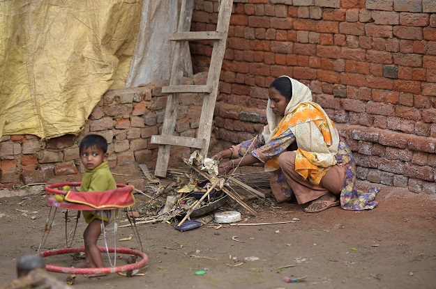 30-year-old Bushra Bibi, who sold one of her kidneys, cleans a courtyard at her home in Bhalwal in Sargodha District, in Punjab. PHOTO: AFP