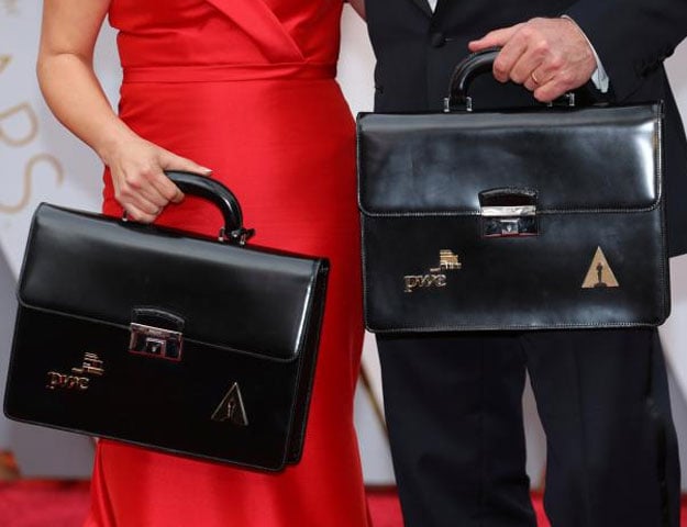 Oscar winning ballots are carried along the red carpet by personnel from Price Waterhouse Coopers as they arrive for the 89th Academy Awards in Hollywood, California, U.S. February 26, 2017. REUTERS/Mike Blake