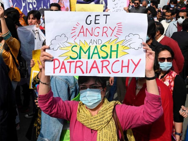 aurat march activists hold placards during a demonstration to mark international women s day in lahore on march 8 2022 photo afp