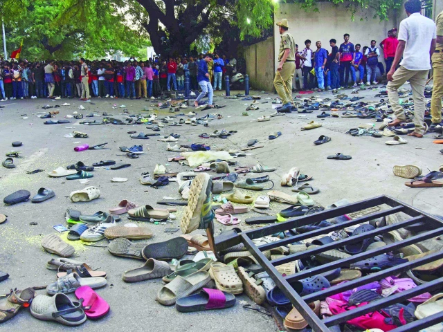 fans stand next to abandonned shoes and a fallen barriers following a stampede during celebrations a day after royal challengers bengaluru s victory at the indian premier league ipl outside the m chinnaswamy stadium in bengaluru on wednesday evening photo afp fans stand next to abandonned shoes and a fallen barriers following a stampede during celebrations a day after royal challengers bengaluru s victory at the indian premier league ipl outside the m chinnaswamy stadium in bengaluru on wednesday evening photo afp
