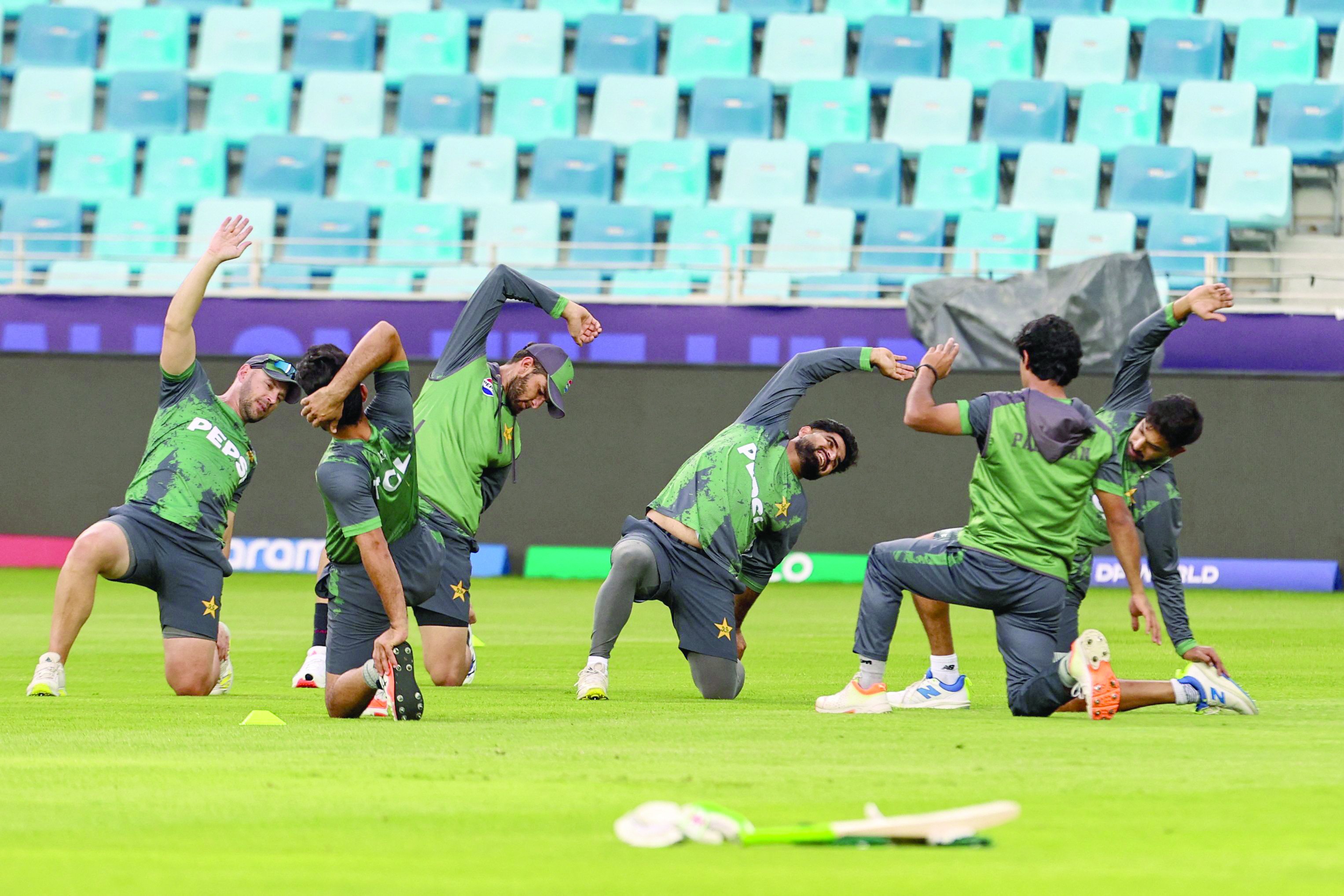 pakistan s players stretch during a practice session at the dubai international stadium on eve of their champions trophy match against india photo afp