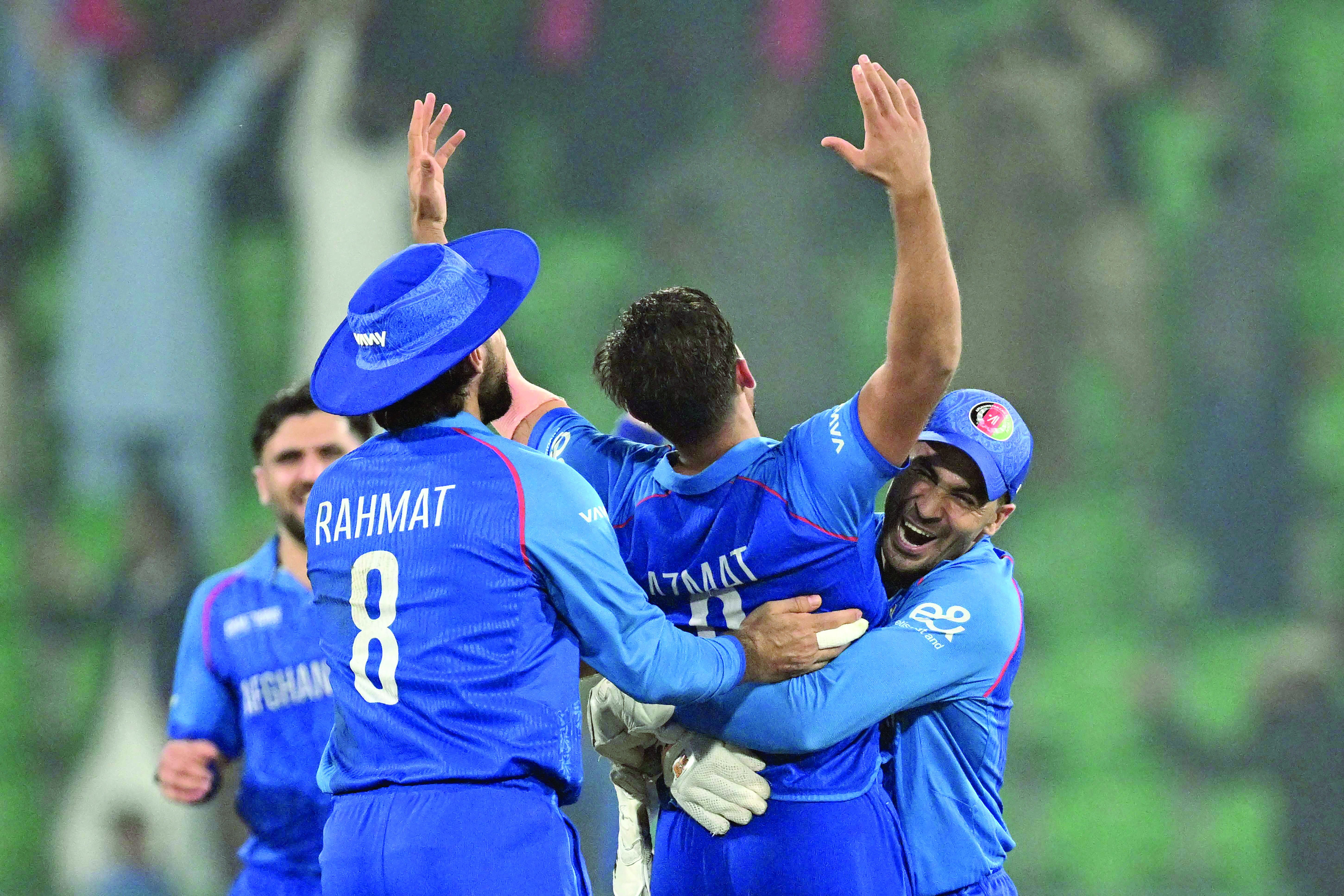 afghanistan players celebrate after beating england in the key icc champions trophy match at lahore on wednesday photo afp