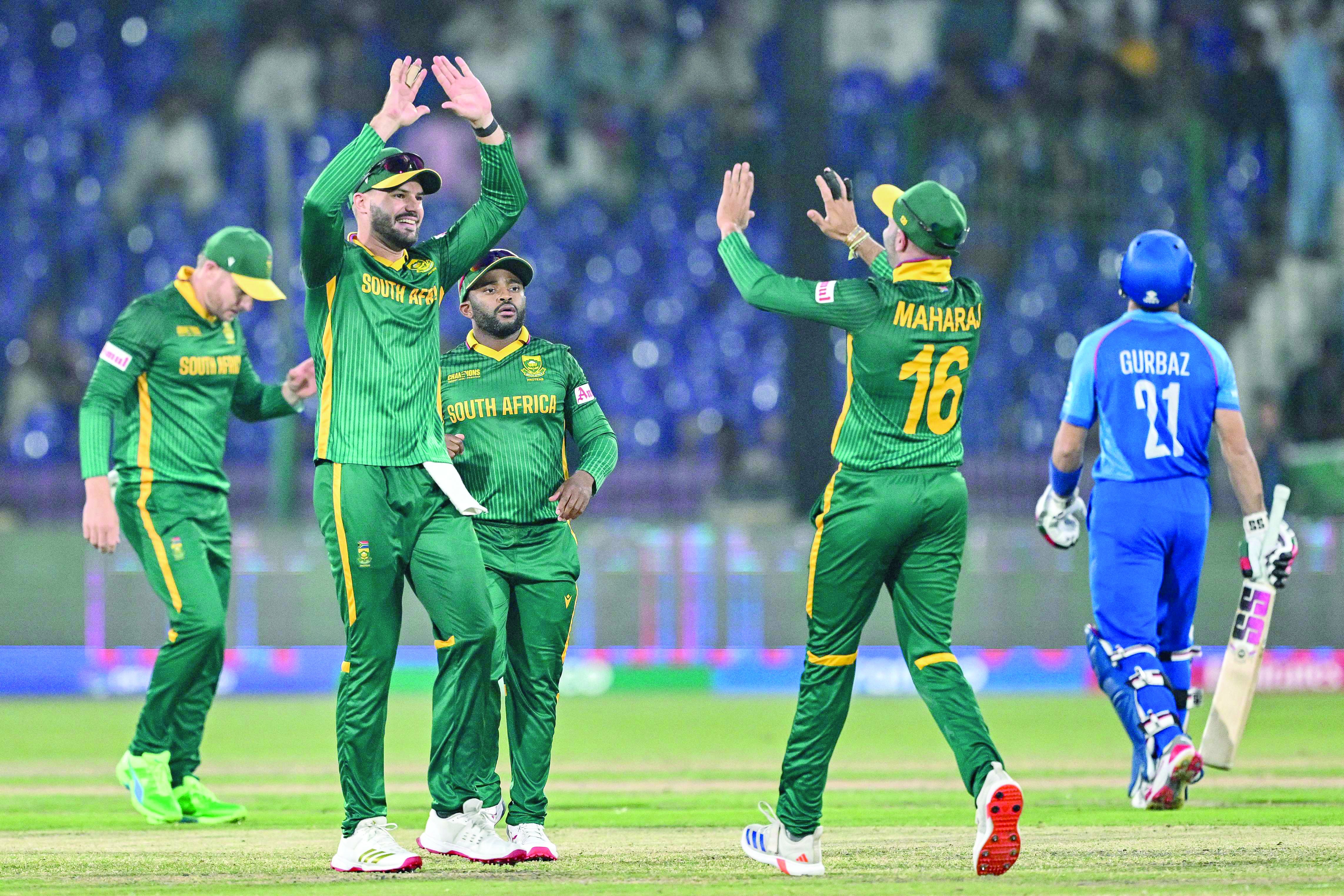 south africa s players celebrate the dismissal of afghanistan s rahmanullah gurbaz r during the icc champions trophy match at the national stadium in karachi on friday photo afp