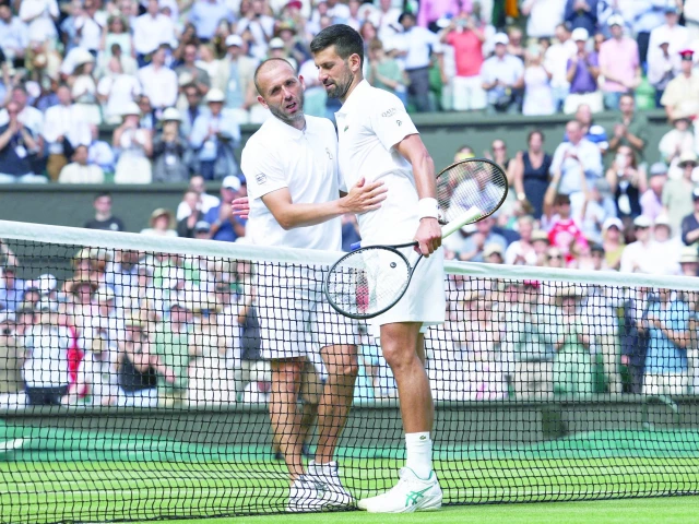 serbia s novak djokovic r embraces britain s daniel evans after winning his men s singles second round match on fourth day of wimbledon championships in london photo afp serbia s novak djokovic r embraces britain s daniel evans after winning his men s singles second round match on fourth day of wimbledon championships in london photo afp