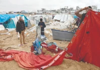 palestinian men re erect a tent shelter the day after the israeli military shelled a tented camp housing displaced families in the gaza city photo afp