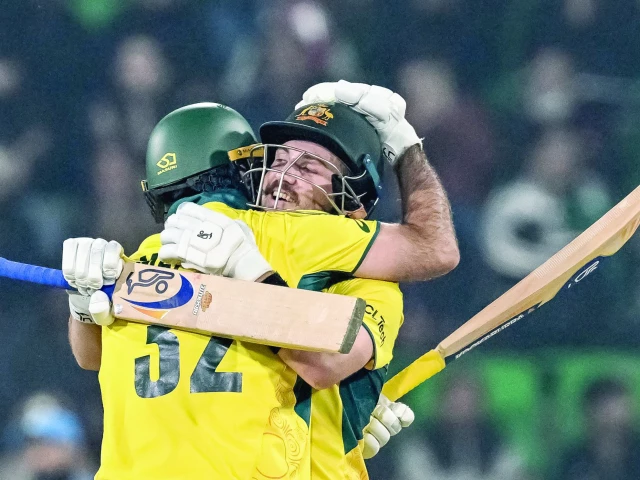 australia s josh inglis r celebrates with teammate maxwell after scoring a century during the icc champions trophy one day international odi against england at the gaddafi stadium in lahore on february 22 photo afp