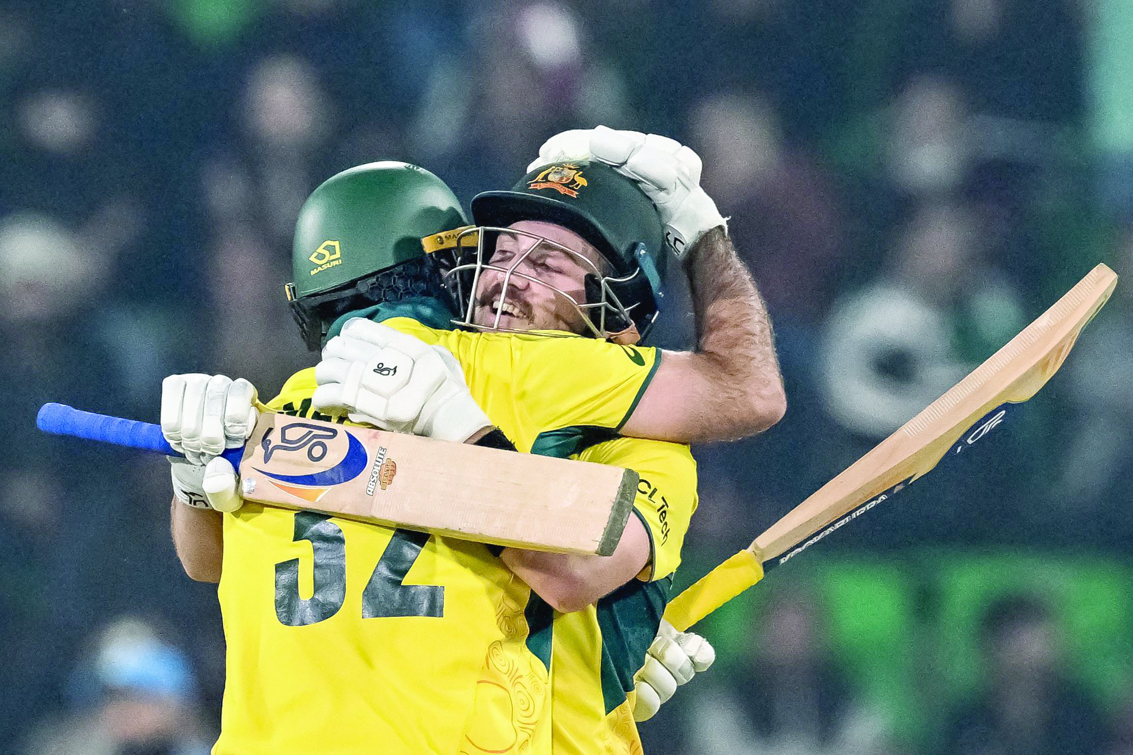 australia s josh inglis r celebrates with teammate maxwell after scoring a century during the icc champions trophy one day international odi against england at the gaddafi stadium in lahore on february 22 photo afp