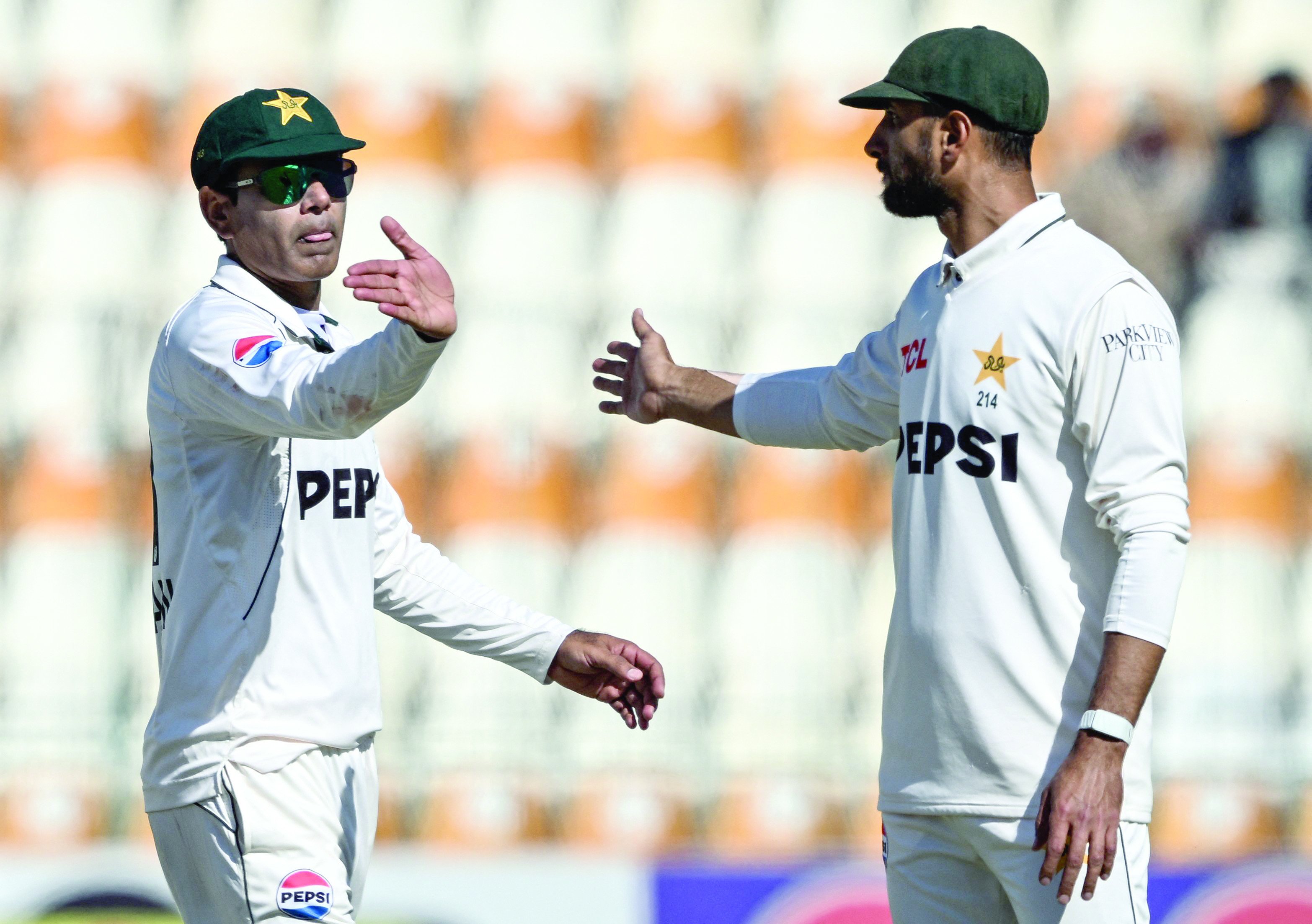 pakistan s noman ali l and his captain shan masood gesture at the end of west indies first innings during the first day of the second cricket test match between pakistan and west indies at the multan cricket stadium in multan on january 25 photo afp