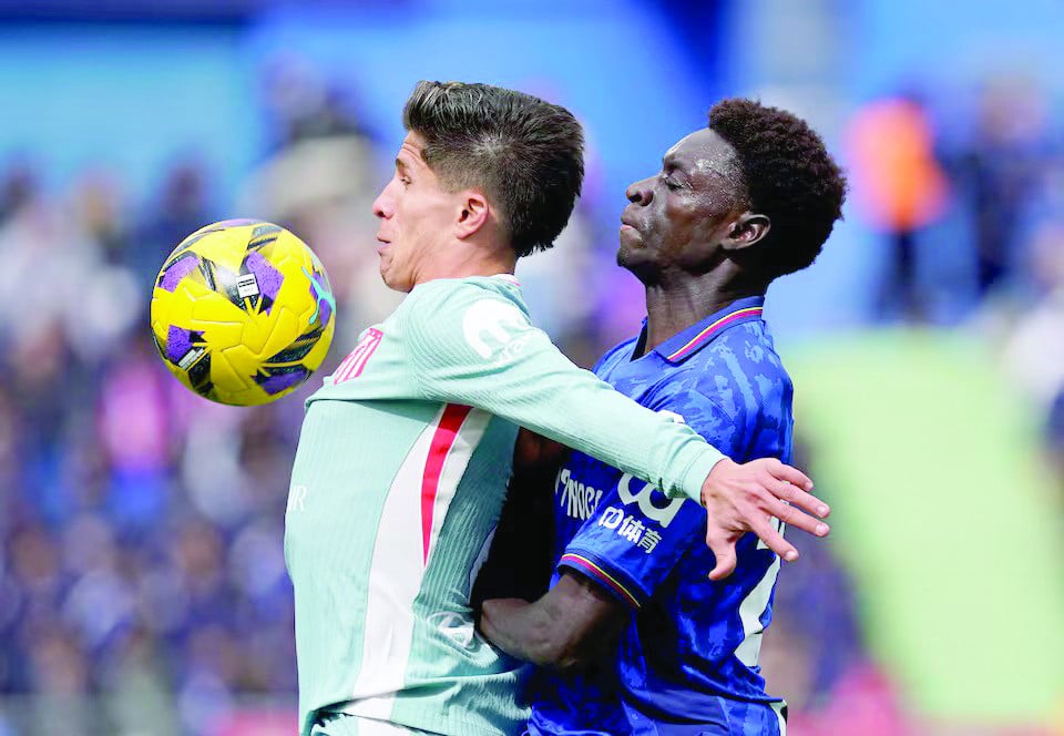 atletico madrid s giuliano simeone in action with getafe s coba da costa during the laliga fixture at estadio coliseum getafe on march 9 photo reuters