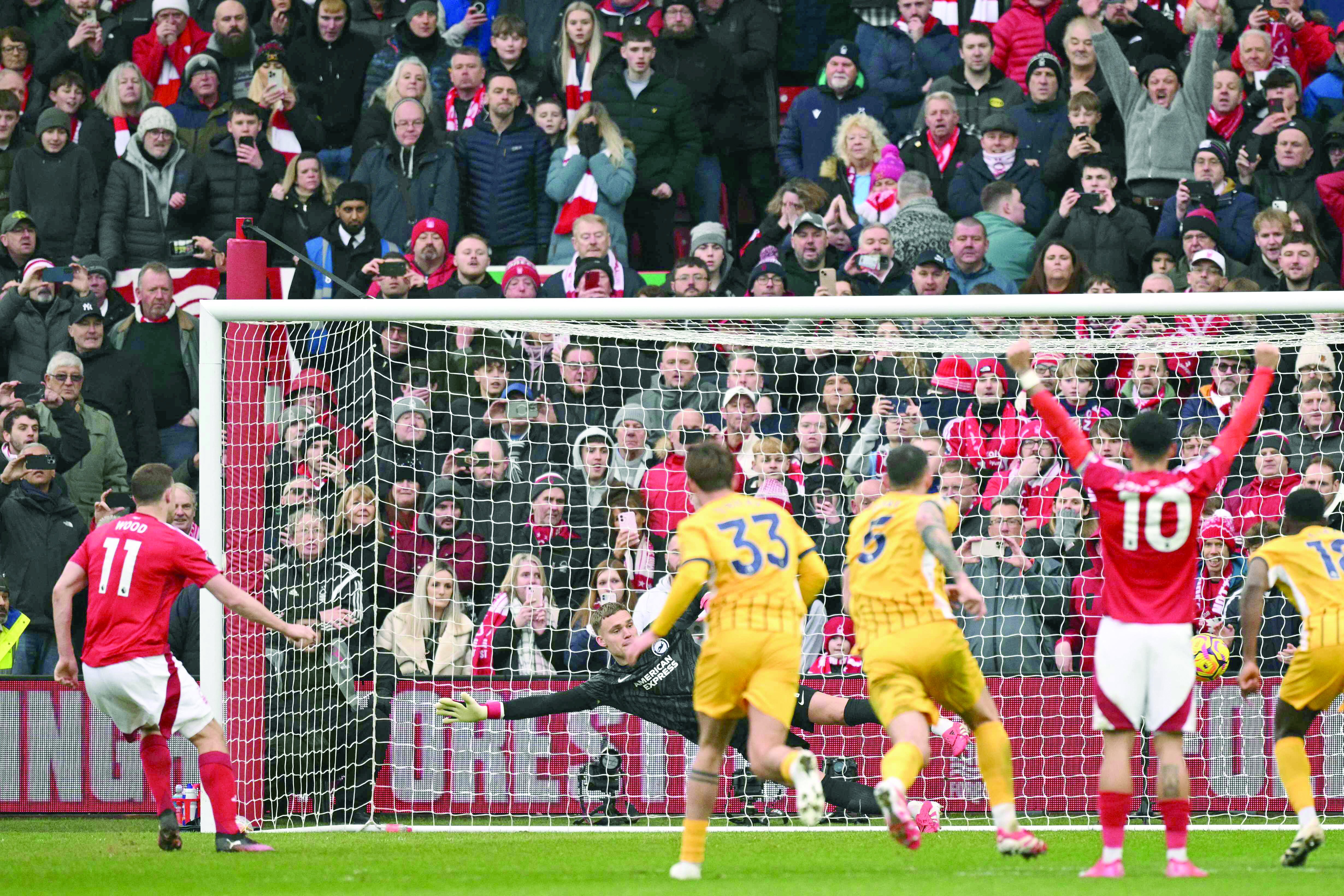 nottingham forest s chris wood l scores his third goal their fifth from the penalty spot during the english premier league football match against brighton and hove albion at the city ground on february 1 photo afp