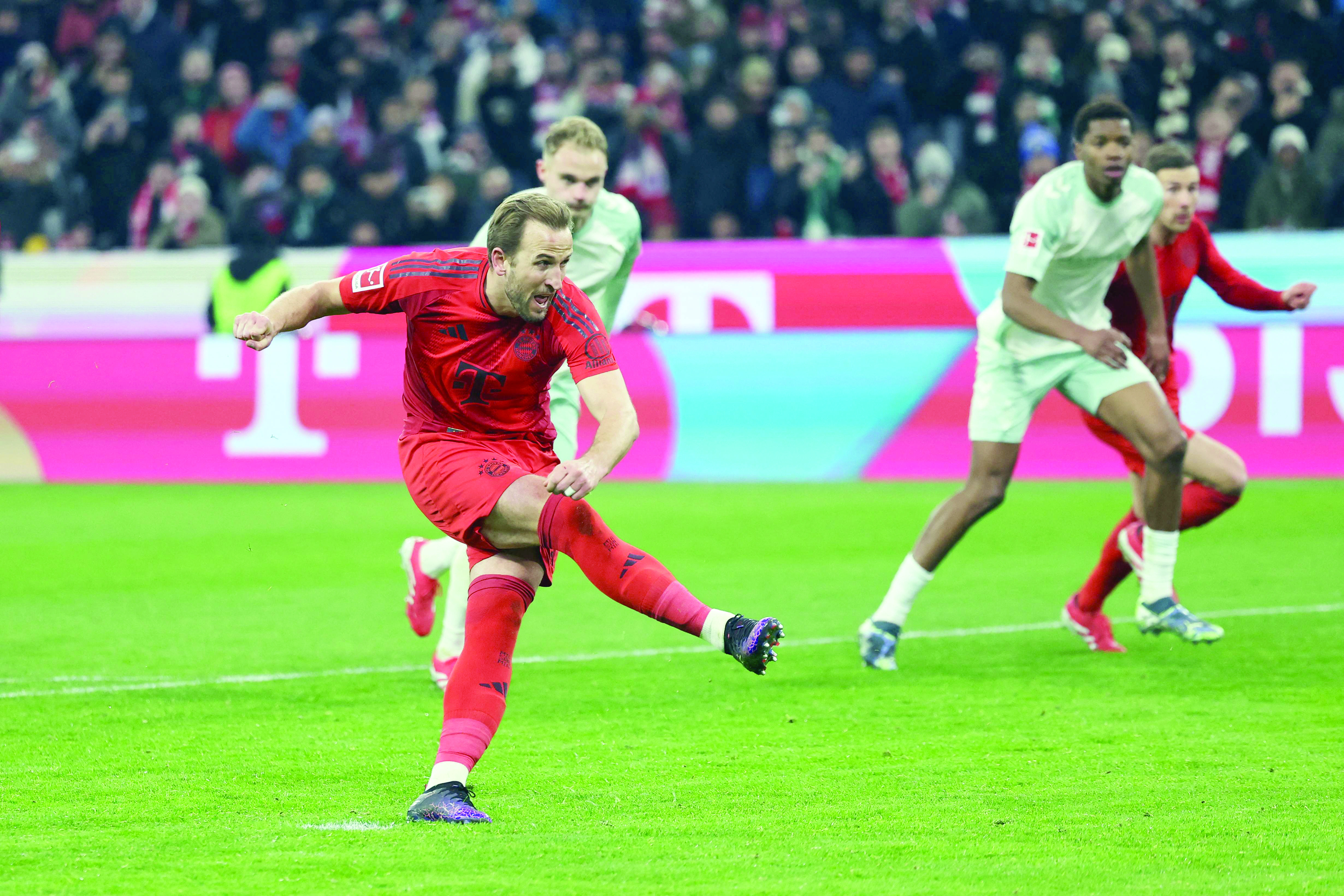 bayern munich s harry kane takes a free kick and scores the third goal during the german first division bundesliga match with sv werder bremen in munich southern germany on february 7 photo afp