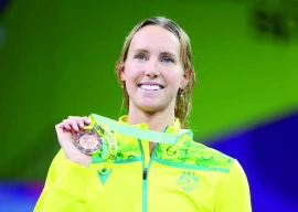 bronze medallist australia s emma mckeon celebrates on the podium during the medal ceremony of the 2022 commonwealth games women s swimming 100m freestyle medal ceremony at sandwell aquatics centre birmingham britain on august 2 2022 photo reuters