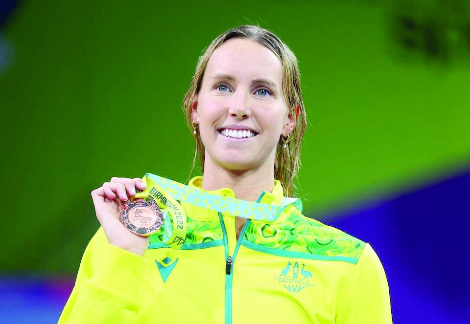 bronze medallist australia s emma mckeon celebrates on the podium during the medal ceremony of the 2022 commonwealth games women s swimming 100m freestyle medal ceremony at sandwell aquatics centre birmingham britain on august 2 2022 photo reuters