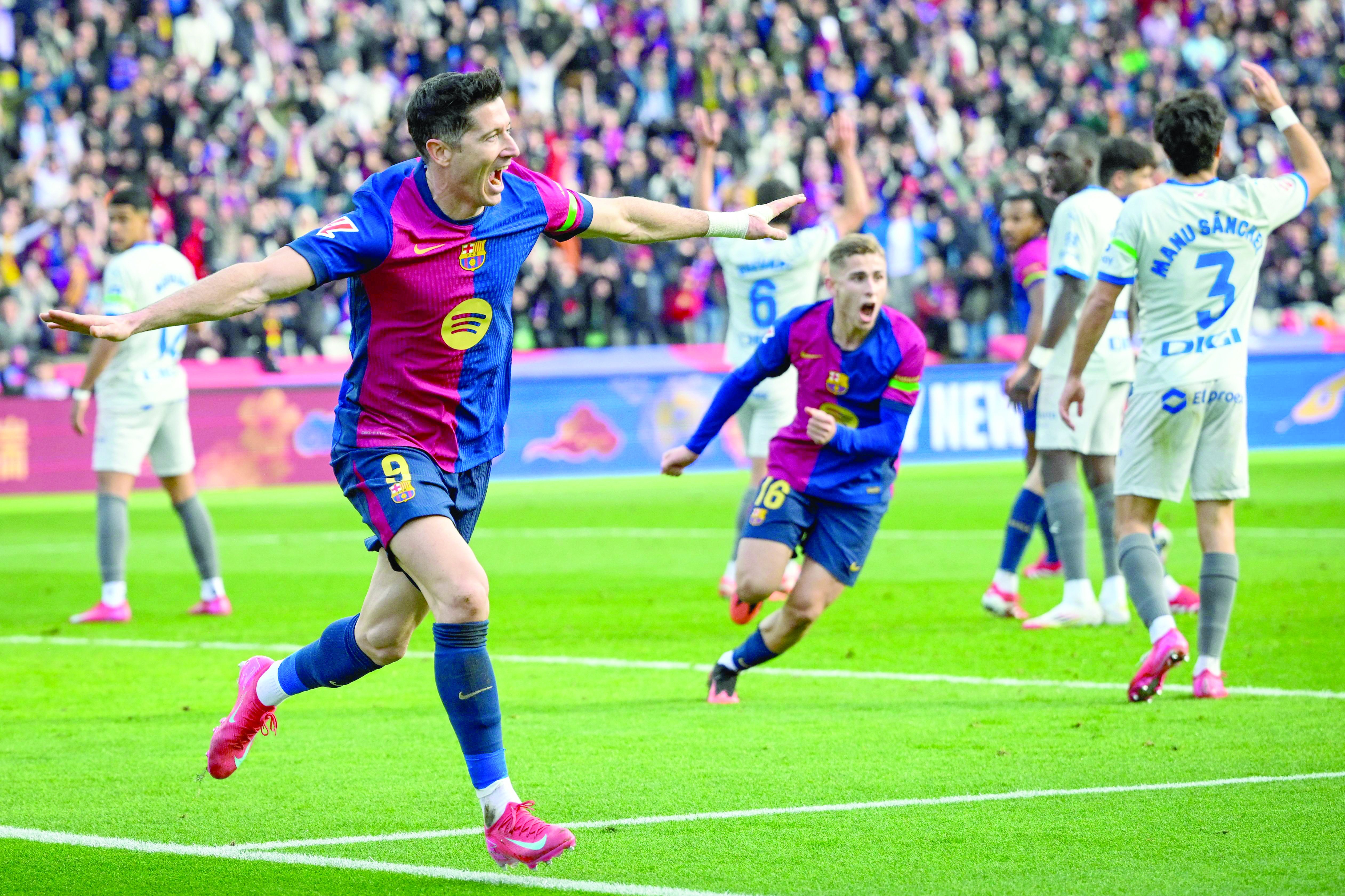 barcelona forward robert lewandowski l celebrates after scoring their first goal during the spanish la liga match against deportivo alaves at the estadi olimpic lluis companys in barcelona on february 2 photo afp