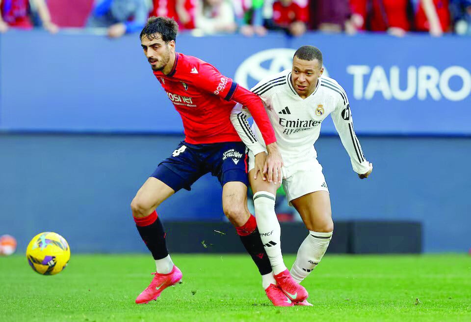 real madrid s kylian mbappe in action with osasuna s alejandro catena during the la liga match at el sadar stadium pamplona on february 15 photo reuters