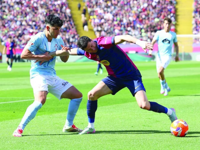 fc barcelona s robert lewandowski in action with celta vigo s yoel lago during the la liga match at estadi olimpic lluis companys barcelona spain on april 19 photo reuters fc barcelona s robert lewandowski in action with celta vigo s yoel lago during the la liga match at estadi olimpic lluis companys barcelona spain on april 19 photo reuters