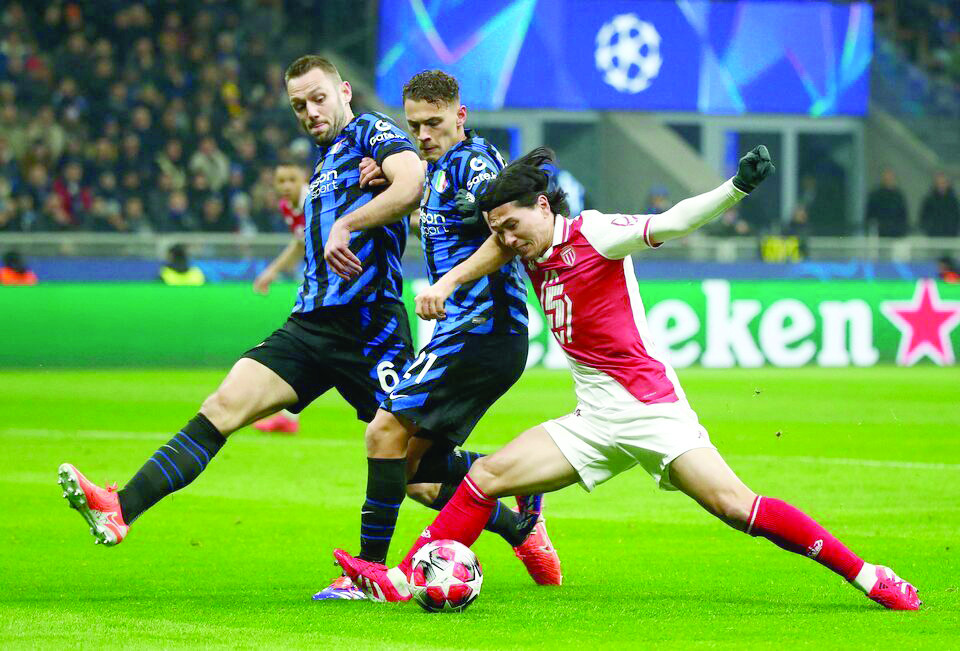 as monaco s takumi minamino in action with inter milan s kristjan asllani and inter milan s stefan de vrij during the champions league match at san siro milan on january 29 photo reuters