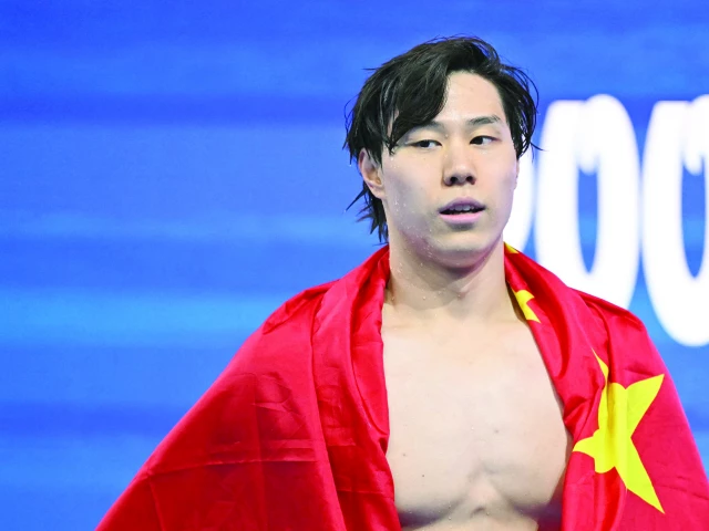 china s swimmer qin haiyang celebrates his victory in the men s 200m breaststroke swimming event during the 2025 world aquatics championships in singapore photo afp
