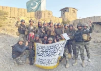pakistani soldiers pose with the national flag at a captured check post inside afghanistan while showing respect for the enemy flag