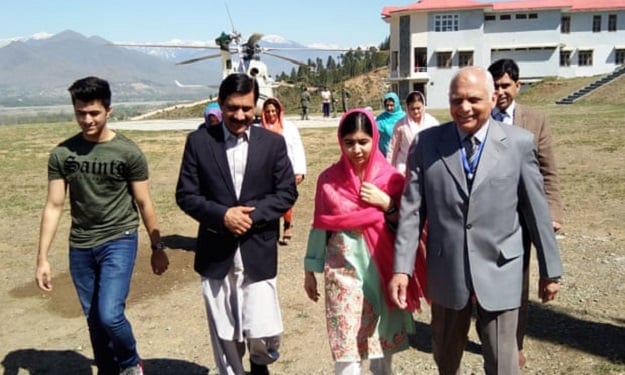 Malala Yousafzai and her father, Ziauddin, during her visit to Pakistan. PHOTO: AFP