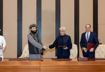defence minister khawaja muhammad asif and afghan defence minister mullah mohammad yaqoob mujahid shake hands following the signing of a ceasefire agreement mediated by qatar and turkey in doha on october 19 photo reuters