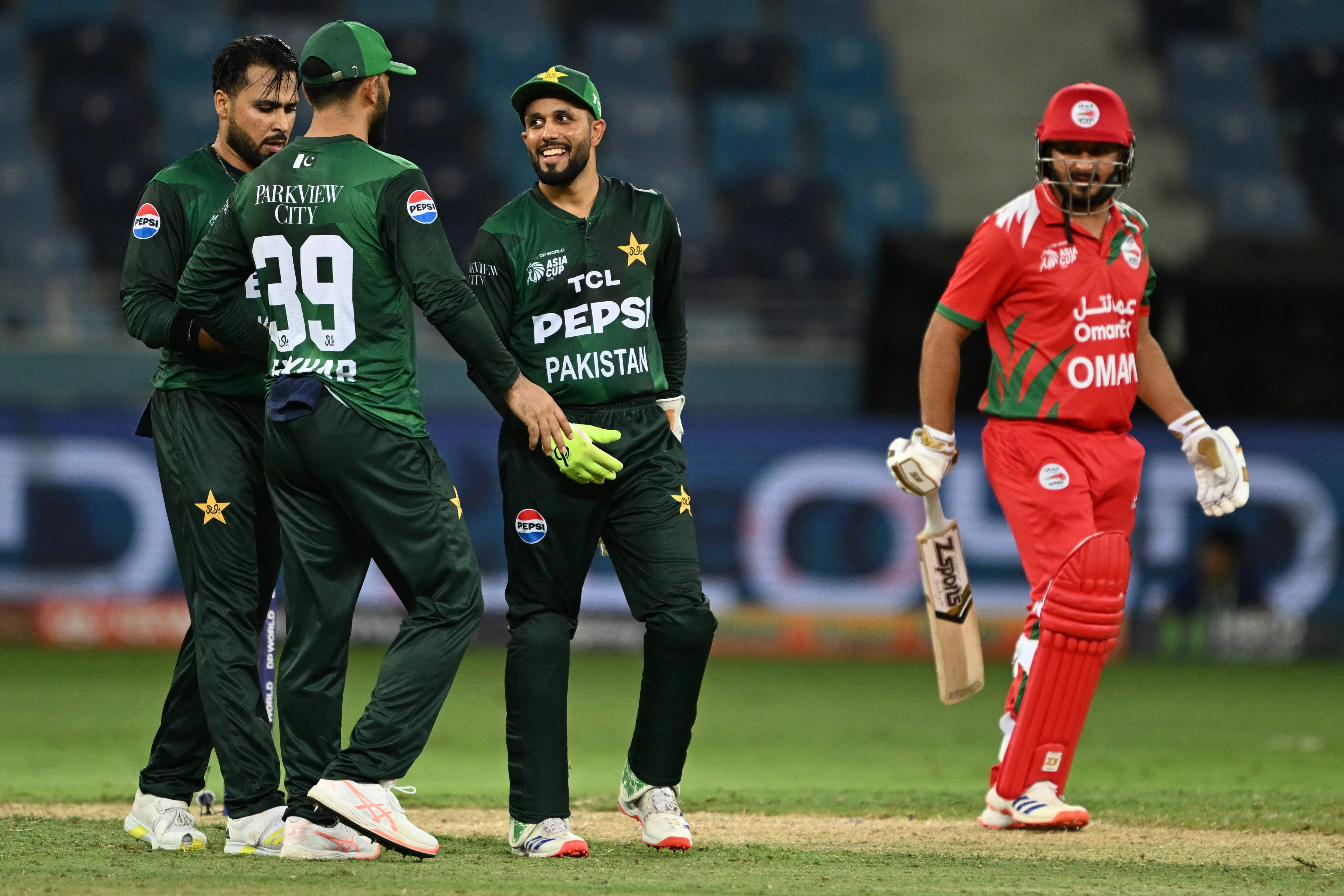 pakistan s team player celebrates the dismissal of oman s zikria islam r during the asia cup 2025 twenty20 international cricket match between oman and pakistan at the dubai international stadium in dubai on september 12 2025 photo afp