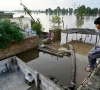 a flood affected villager looks at the overflowing river sutlej as he sits over the rooftop of his house in kasur district punjab province on september 3 2025 photo afp