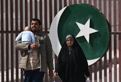 pakistanis walk across the taftan border as they return from iran in balochistan province on march 3 2026 amid ongoing us israel strikes on iran photo afp