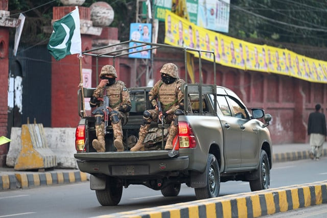 military troops patrol near a polling station during pakistan s national elections in lahore on february 8 2024 photo afp military troops patrol near a polling station during pakistan s national elections in lahore on february 8 2024 photo afp