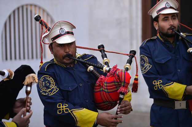 In this picture taken on January 25, 2019, a Pakistani musical band perform with bagpipes made at the Mid East bagpipe factory in the eastern city of Sialkot. PHOTO: AFP