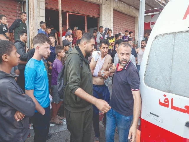 palestinian rescuers arrive in an ambulance to evacuate injured people after an israeli drone opened fire on civilian gatherings near an aid distribution point in the central gaza strip photo afp