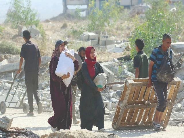 palestinians carry humanitarian aid in gaza strip photo afp