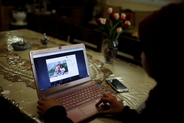 Palestinian woman Fatma Abu Musabbeh views one of her Instagram posts on her laptop in her family house in the central Gaza Strip. PHOTO: REUTERS