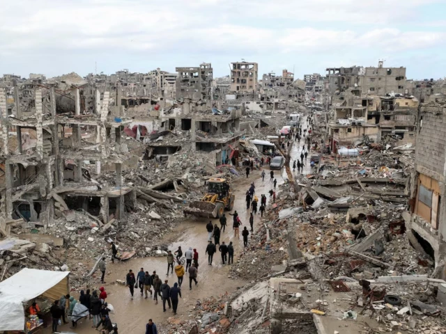 palestinians walk past the rubble of buildings destroyed during the israeli offensive on a rainy day amid a ceasefire between israel and hamas in gaza on february 6 2025 photo reuters file palestinians walk past the rubble of buildings destroyed during the israeli offensive on a rainy day amid a ceasefire between israel and hamas in gaza on february 6 2025 photo reuters file