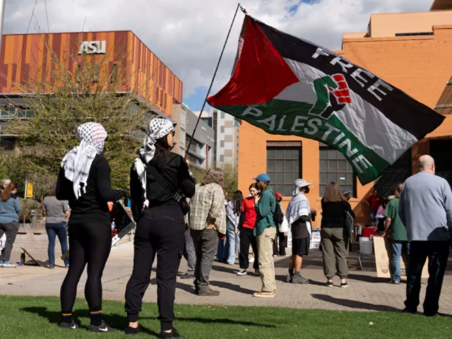 protesters wearing keffiyehs wave a pro palestinian flag during a protest against the ice detention of palestinian activist and columbia university graduate student mahmoud khalil near arizona state university asu in phoenix arizona u s march 15 2025 photo reuters