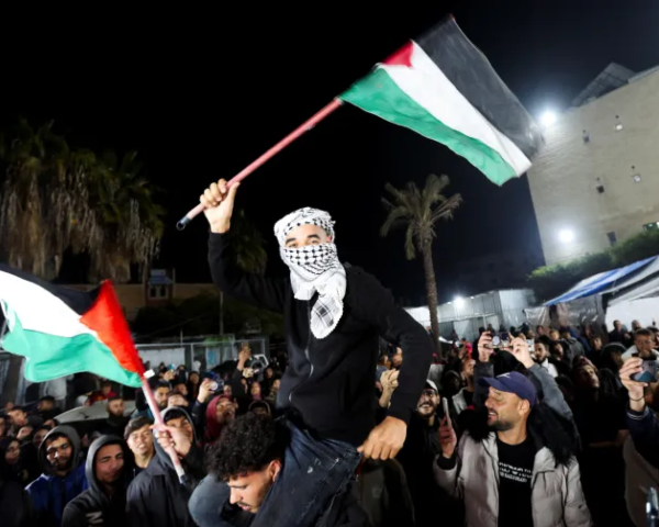 people wave palestinian flags in deir el balah photo reuters