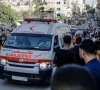 an ambulance waiting in the middle of the road in palestine as onlookers gather around it photo aa file