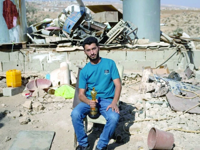basel adra holds up his oscar in the village of at tuwani in the occupied west bank photo al monitor basel adra holds up his oscar in the village of at tuwani in the occupied west bank photo al monitor