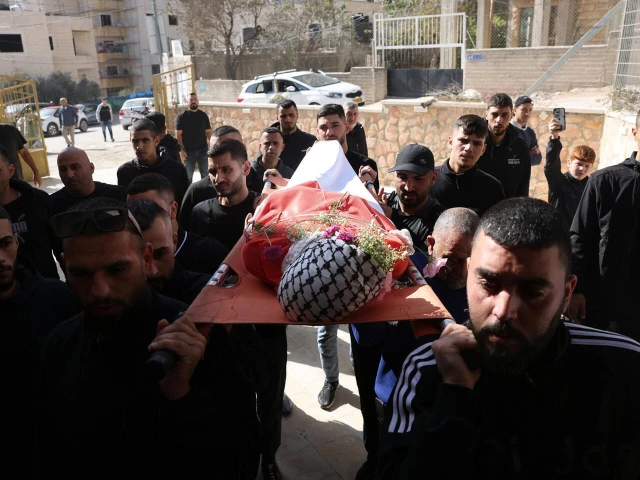 mourners carry the body of 16 year old palestinian sami mashayekh during his funeral photo afp