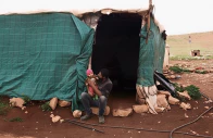 suhaib abu kbash sits with his child on his lap outside their makeshift house in a palestinian bedouin community in the jordan valley in the israeli occupied west bank march 19 2026 photo reuters