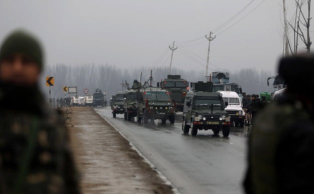 Indian security forces stand guard along the Srinagar-Jammu Highway. -AFP