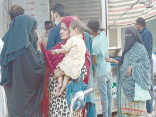 beggars swarm bohri bazaar and ma jinnah road targeting shoppers and pedestrians with pleas for alms photo jalal qureshi express