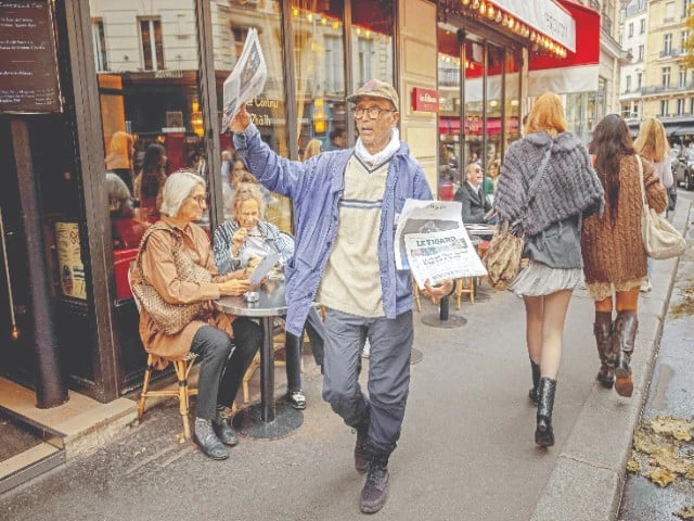 pakistani born ali akbar sells newspaper copies in a street in the latin quarter of paris photos afp