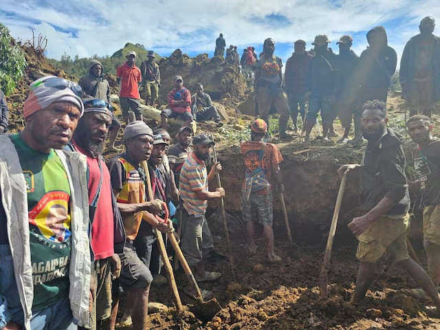 a locals gather amid the damage after a landslide in maip mulitaka enga province papua new guinea may 24 2024 in this obtained image emmanuel eralia via photo reuters