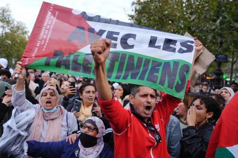 a man holds a palestinian flag during a demonstration in paris on october 19 2023 photo afp