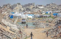 boys walk past the rubble of destroyed buildings in the jabalia camp for palestinian refugees in the northern gaza strip photo afp